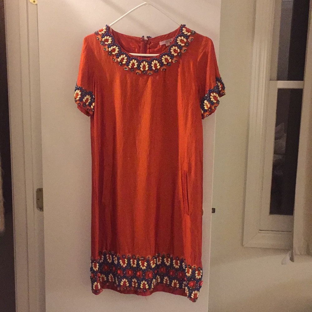 Calypso orange silk dress.
